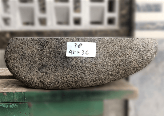 Side view of 18×14 inch brown river stone sink in countertop, showing triangular shape