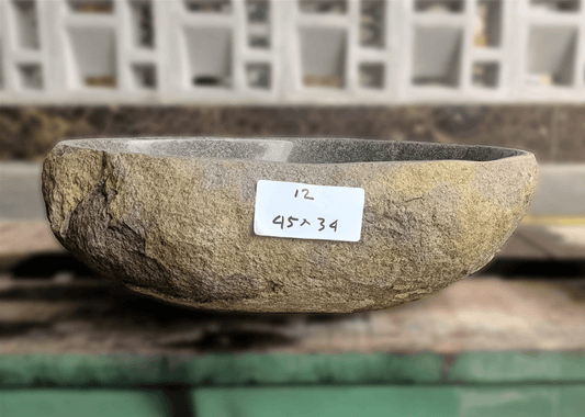 alt="Side view of 18×13 inch river stone bathroom sink installed in countertop"