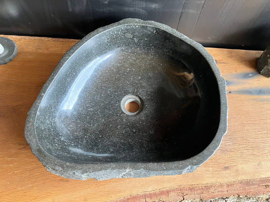 Andesite stone bathroom vessel sink ANS-004 showing its rough chiseled exterior and triangular form