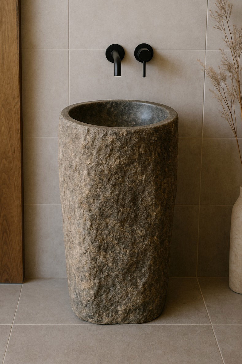 River stone pedestal sink with natural rough texture and polished basin in modern bathroom