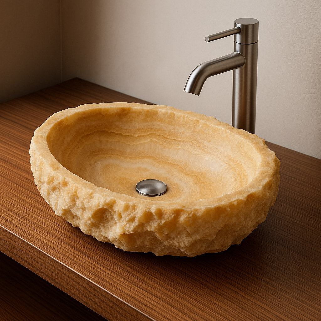 Handcrafted onyx vessel sink with rough natural edges and polished interior, placed on a wooden countertop with a modern metal faucet.