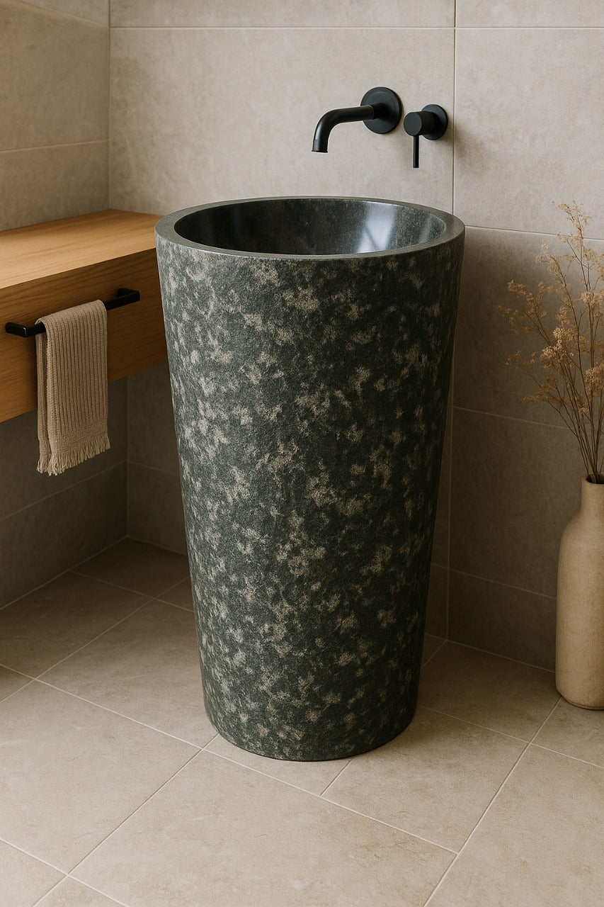 Andesite stone pedestal sink with polished basin and rough textured exterior in modern bathroom interior
