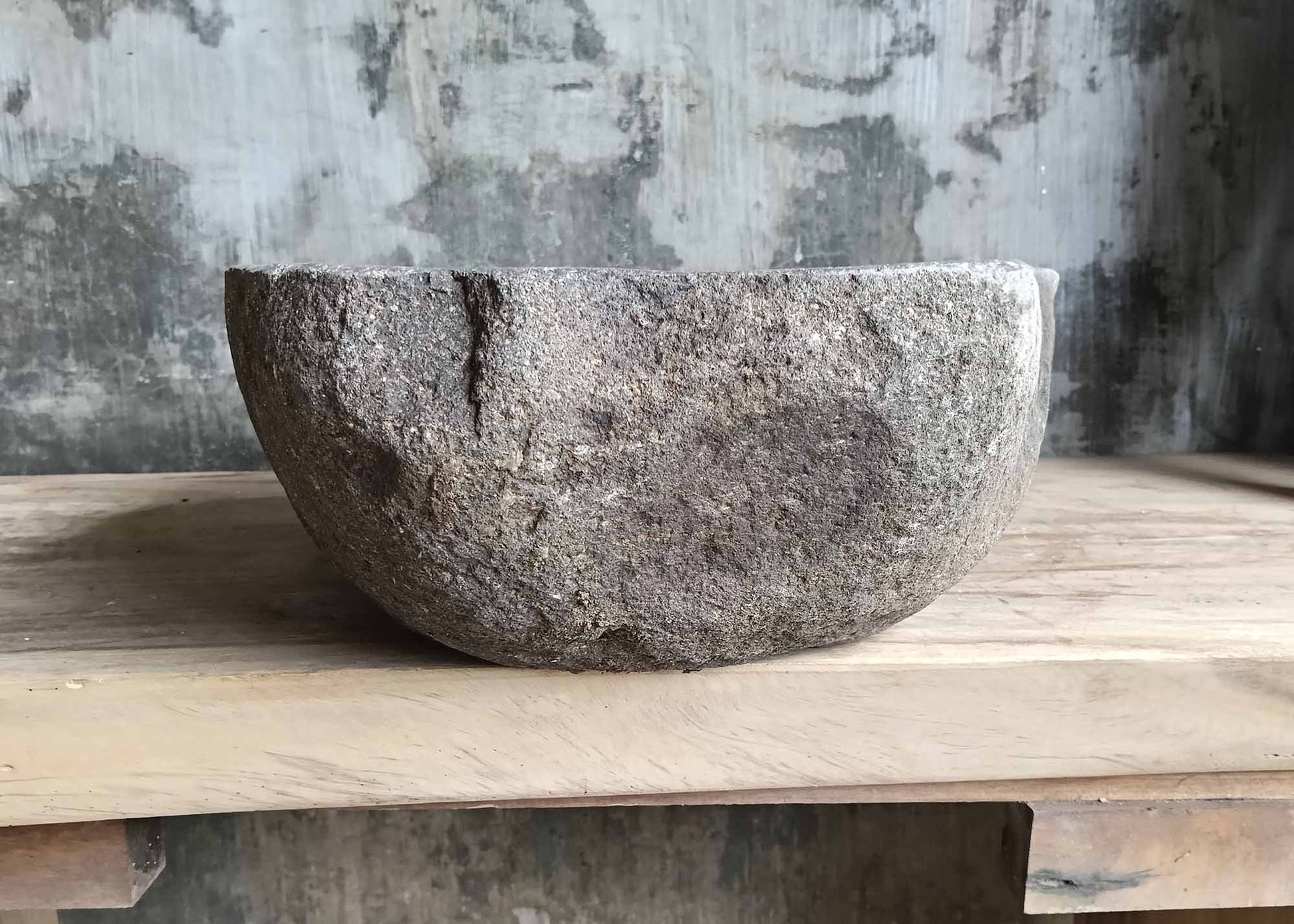 Left side view of river stone sink SKU 6007-5338 with organic shape and rough textured exterior surface
