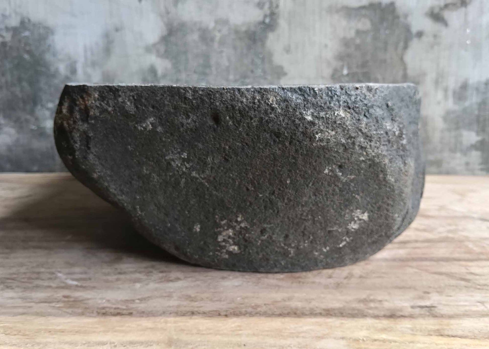 Left side angle of oval dark stone sink 6008-4633 with organic contours
