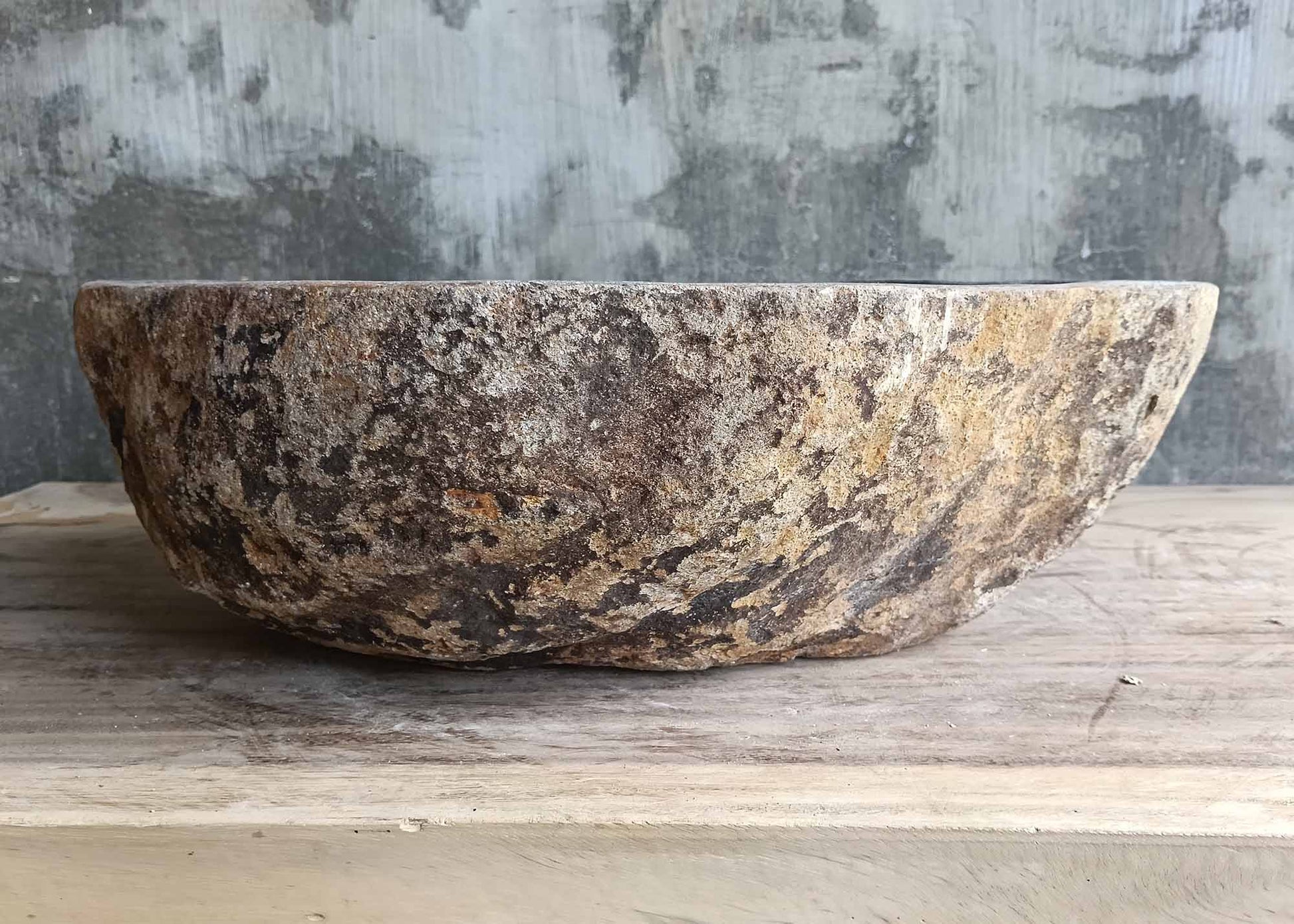 Backside of triangular river sink 6015-4934 with raw stone exterior
