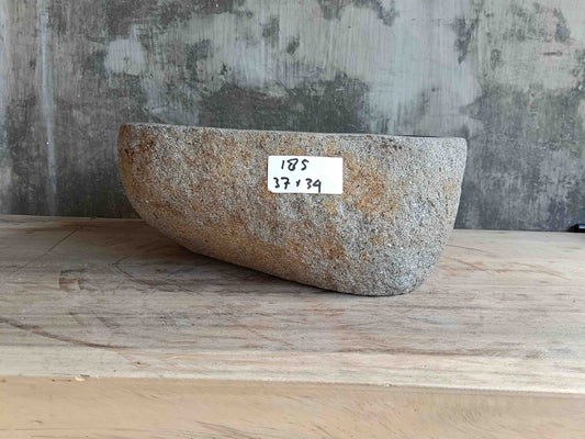 Side view of 15×13 inch light-gray river stone sink installed in countertop
