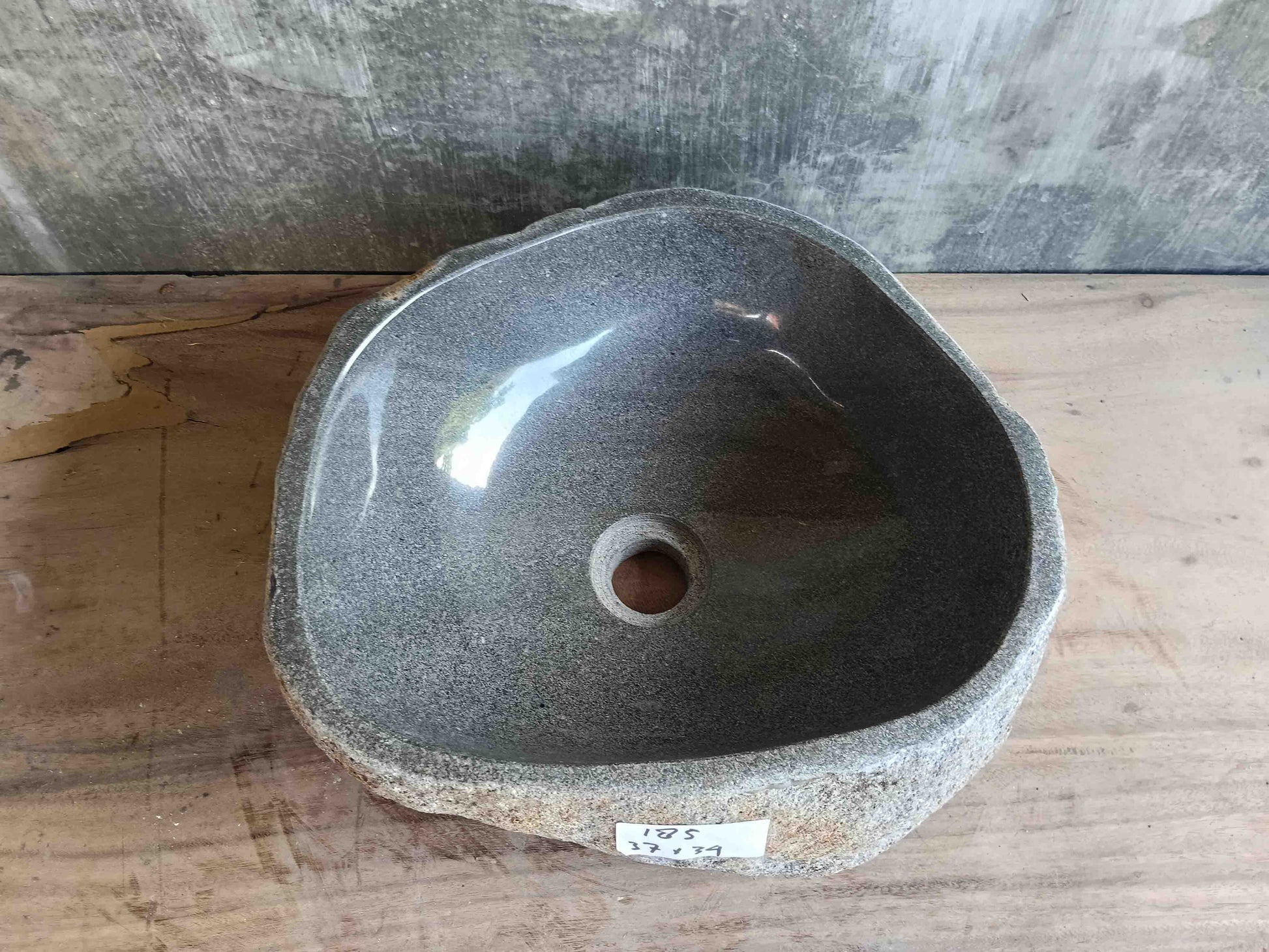 Top view of handcrafted light-gray 15×13 inch river stone sink in irregular form
