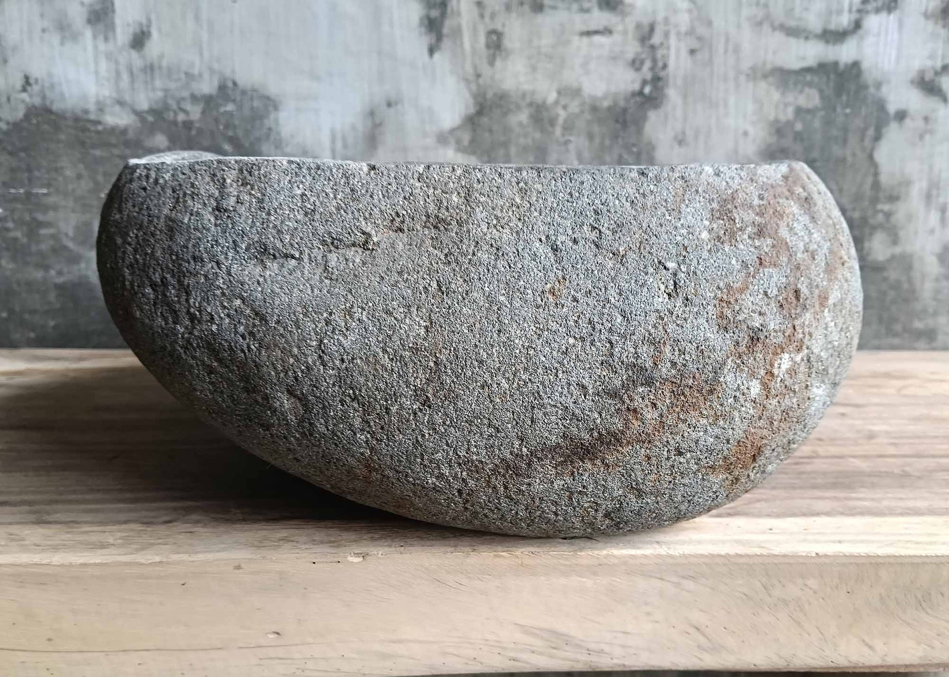 Left side angle of oval dark stone sink 6022-4935 with organic lines
