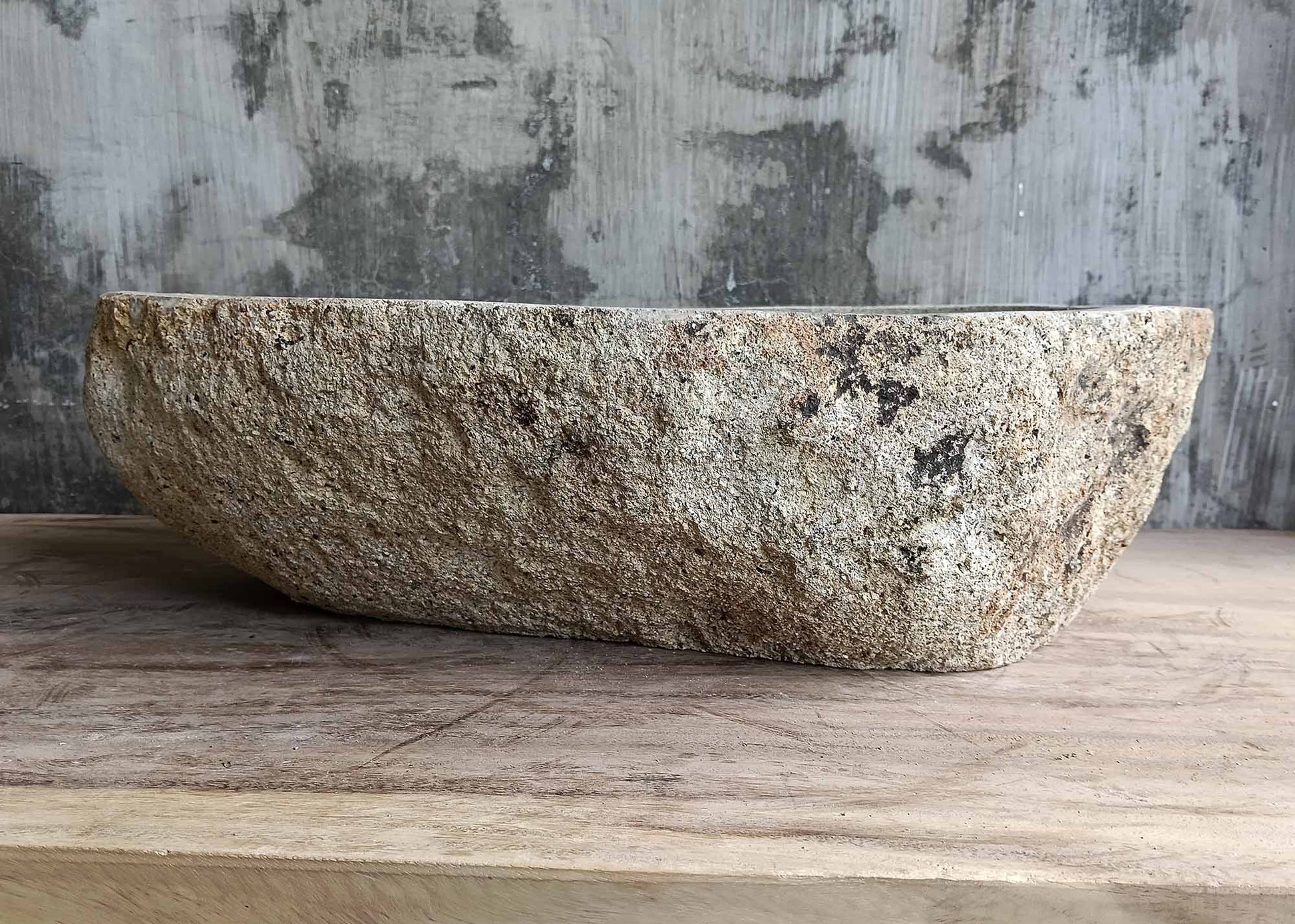Rear view of oval river stone sink SKU 6026-5435 highlighting organic natural stone texture and polished interior surface
