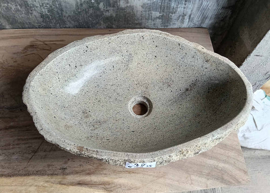 Top view of handcrafted oval river stone sink SKU 6026-5435 with polished light interior and rough textured natural stone exterior
