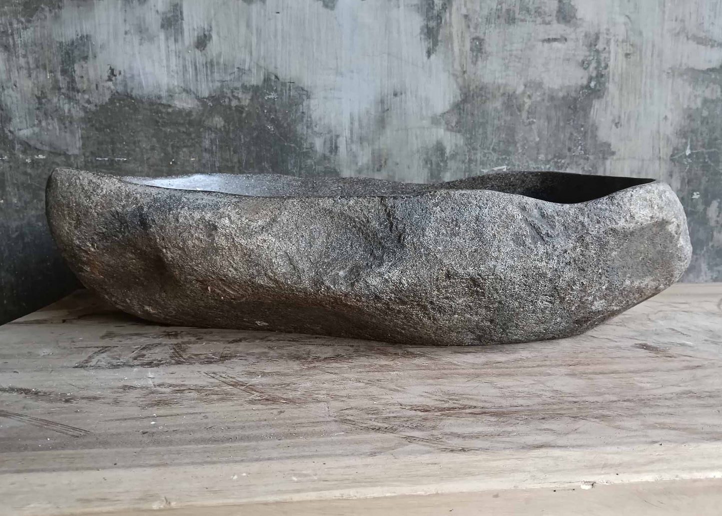 Rear view of oval river stone sink SKU 6046-5534 highlighting natural rough stone texture and smooth interior finish
