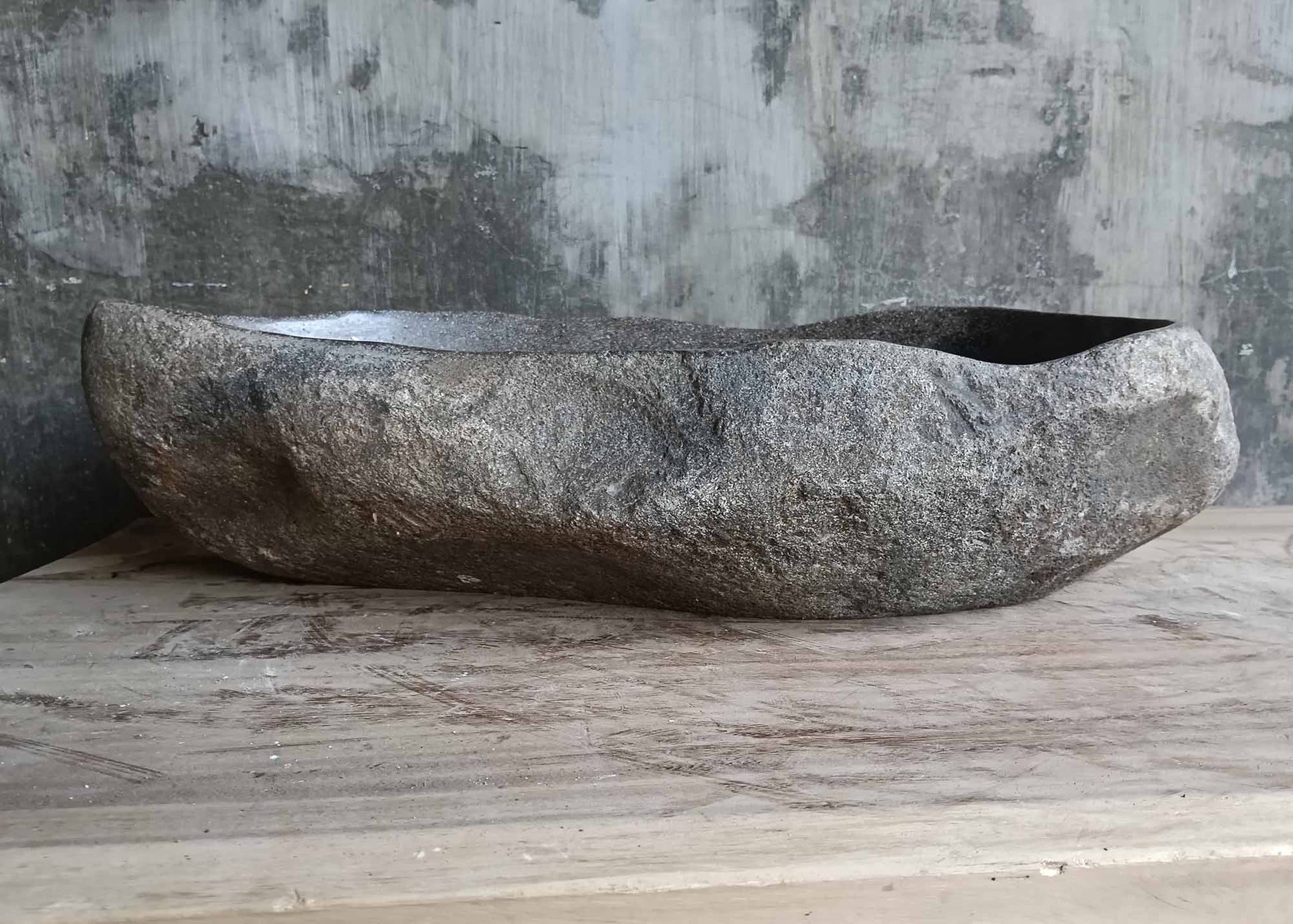 Rear view of oval river stone sink SKU 6046-5534 highlighting natural rough stone texture and smooth interior finish

