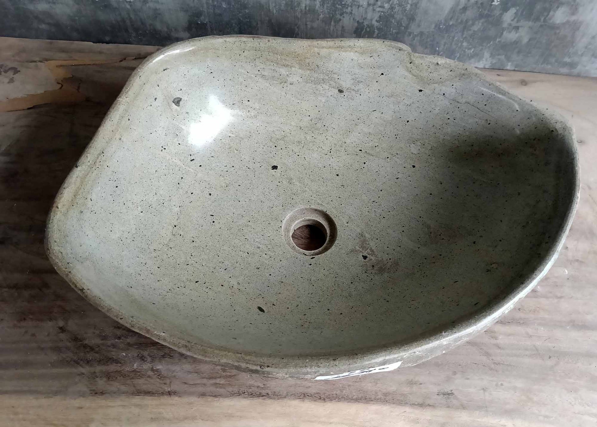 Top view of handcrafted oval river stone sink SKU 6050-5338 with polished light interior and natural textured exterior
