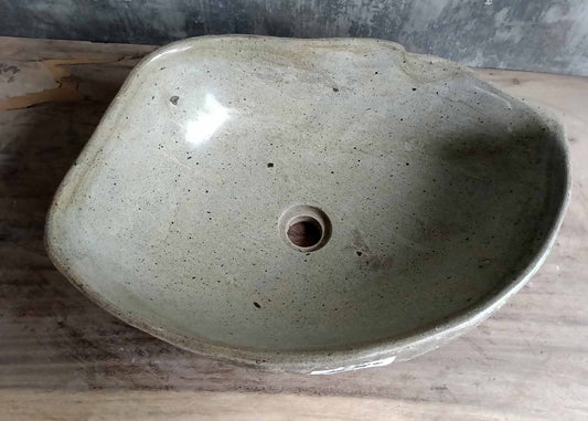 Top view of handcrafted oval river stone sink SKU 6050-5338 with polished light interior and natural textured exterior
