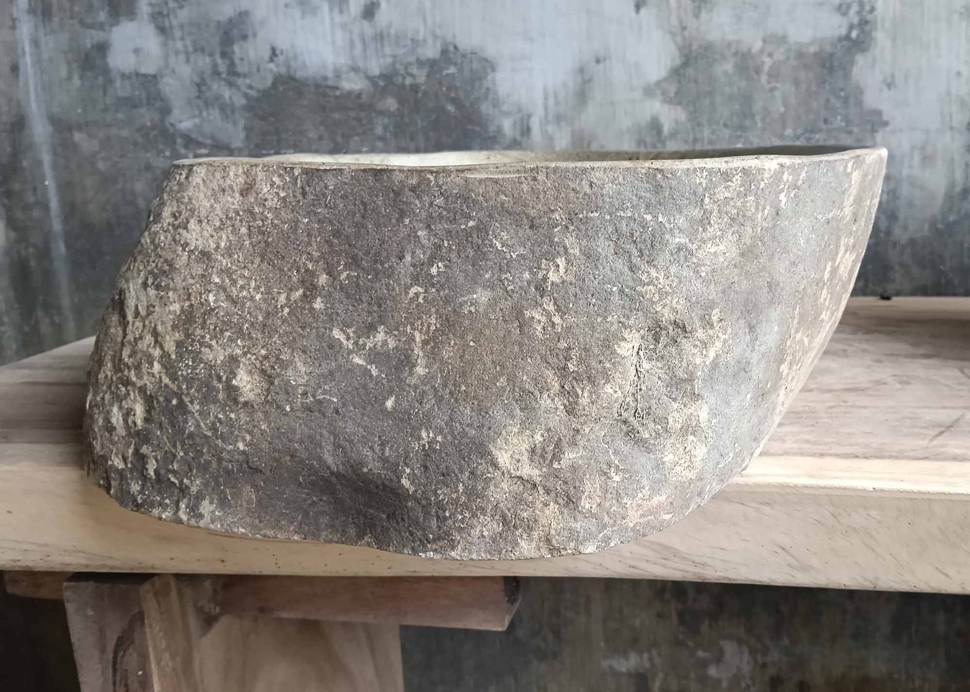 Left side view of river stone sink SKU 6050-5338 with organic shape and rough textured exterior
