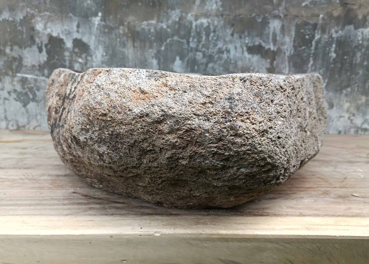 Backside of river stone sink 6070-4940 with raw textured stone exterior
