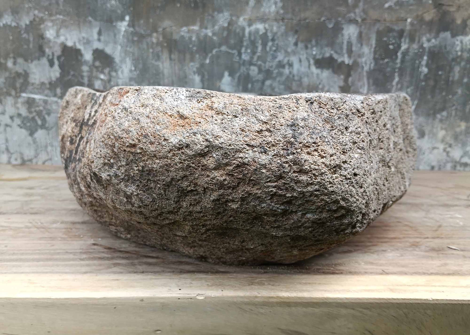 Backside of river stone sink 6070-4940 with raw textured stone exterior
