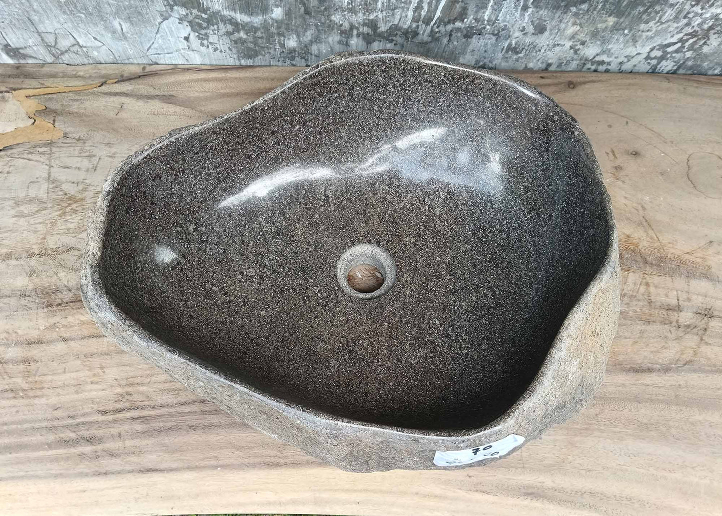 Top view of triangular river stone sink 6070-4940 with polished dark gray interior

