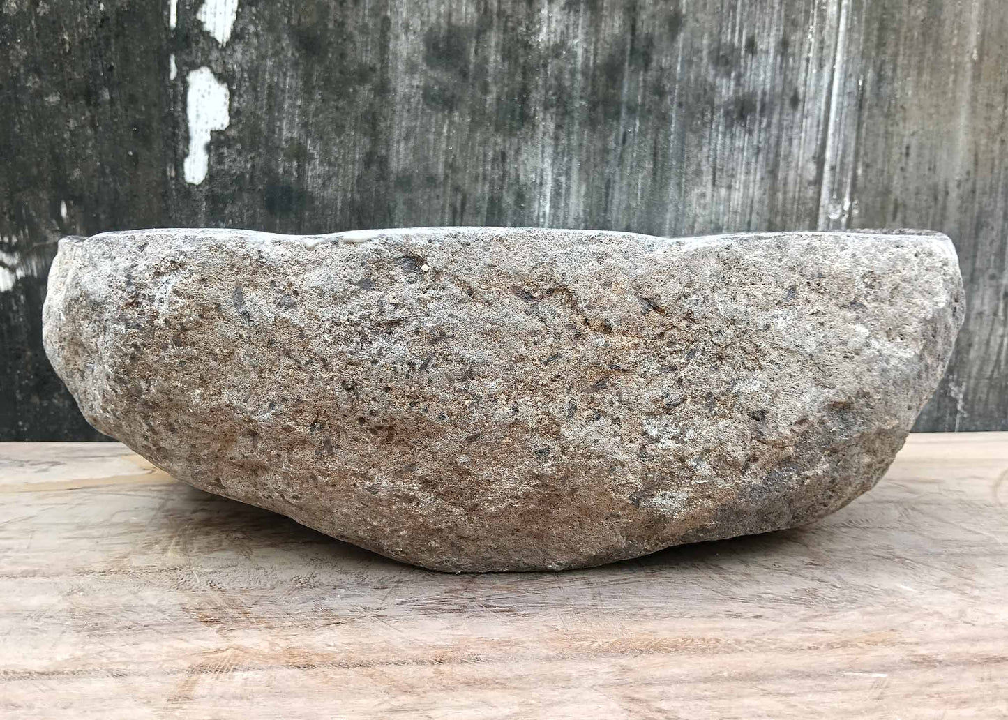 Backside of river stone sink 6075-4733 with raw stone exterior and natural curves
