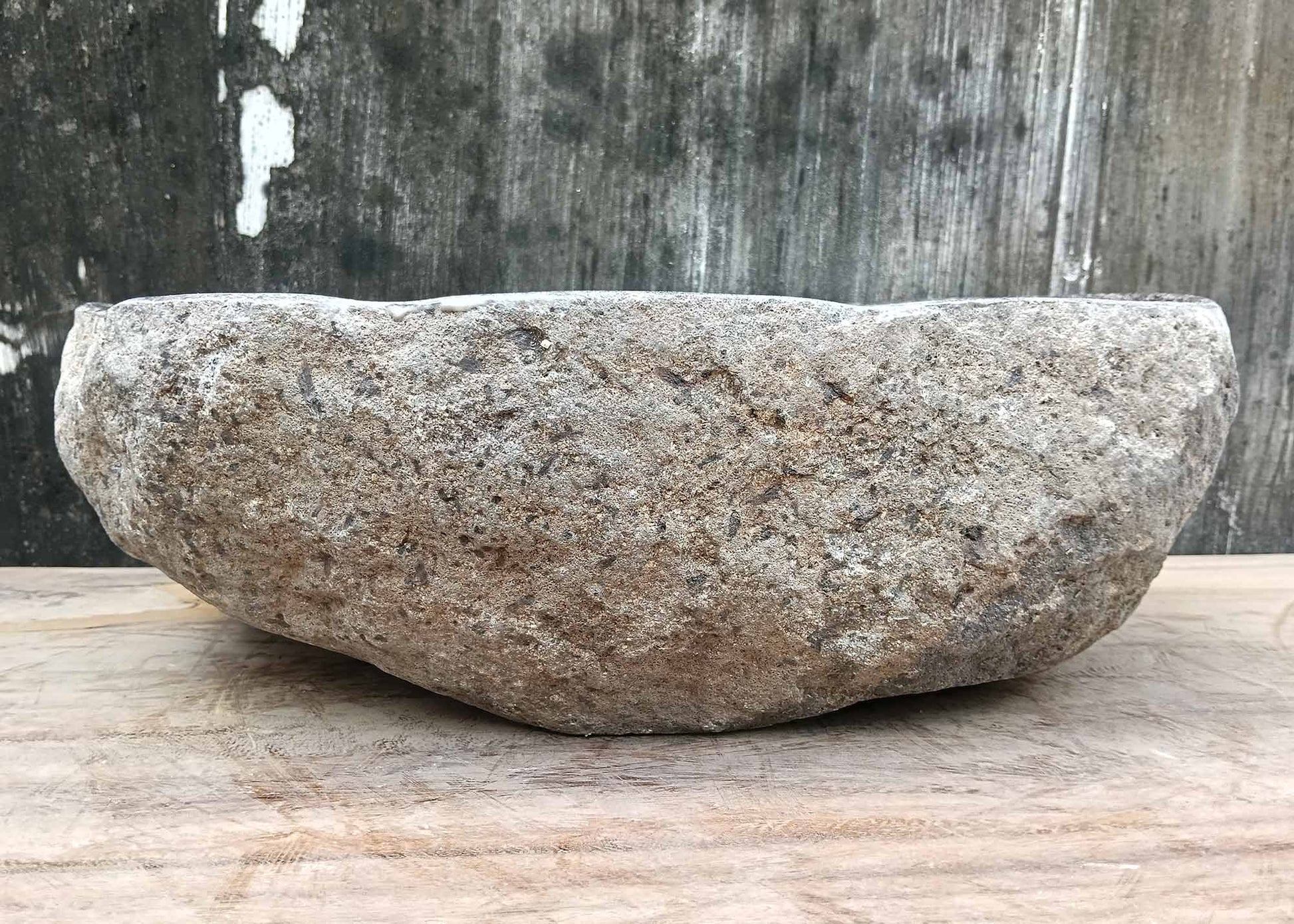 Backside of river stone sink 6075-4733 with raw stone exterior and natural curves
