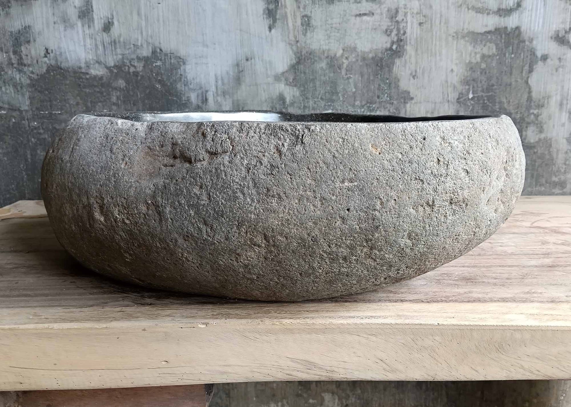 Rear view of triangular river stone sink SKU 6077-5044 highlighting rough natural stone texture and smooth polished basin
