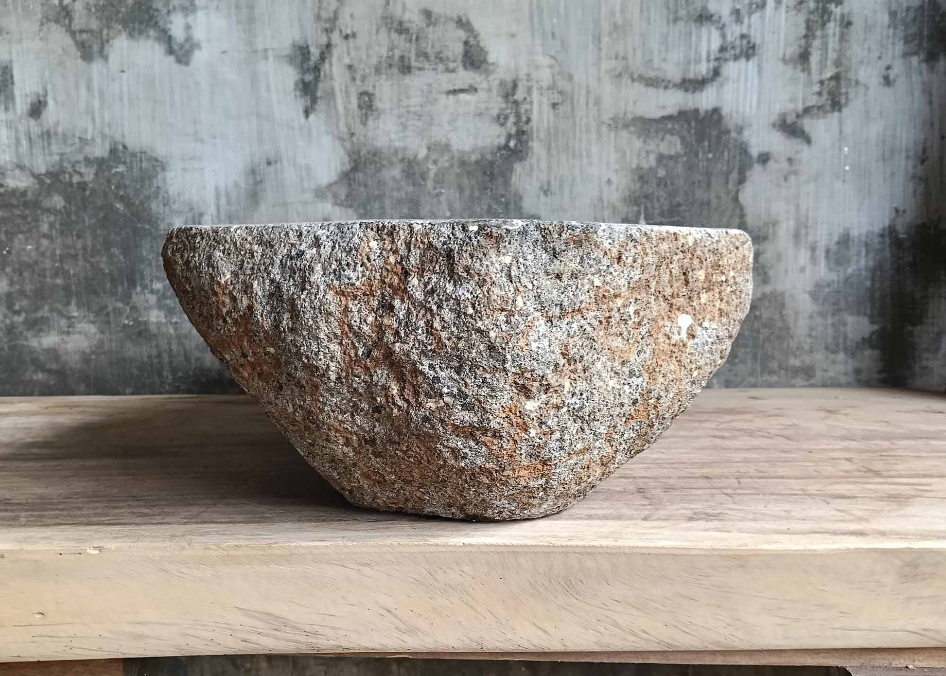 Right side view of handcrafted oval dark gray river stone sink SKU 6083-5335 with rugged exterior and polished interior surface
