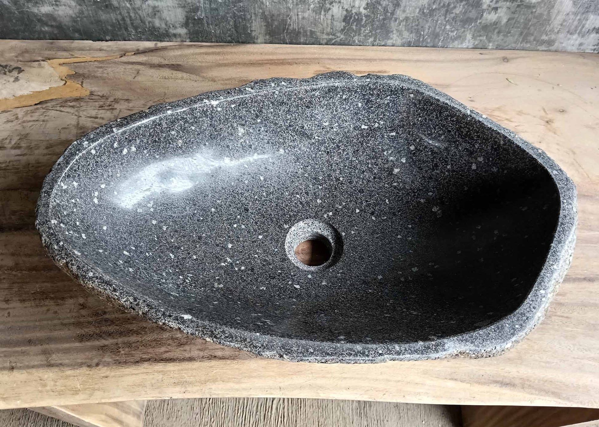 Top view of handcrafted oval dark gray river stone sink SKU 6083-5335 with polished interior and rugged natural exterior texture
