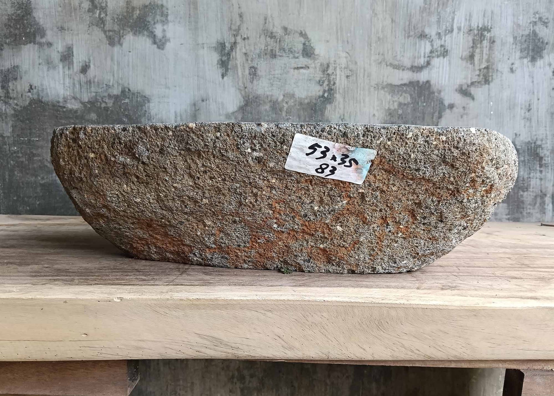 Rear view of oval river stone sink SKU 6083-5335 highlighting rough natural stone texture and smooth polished basin
