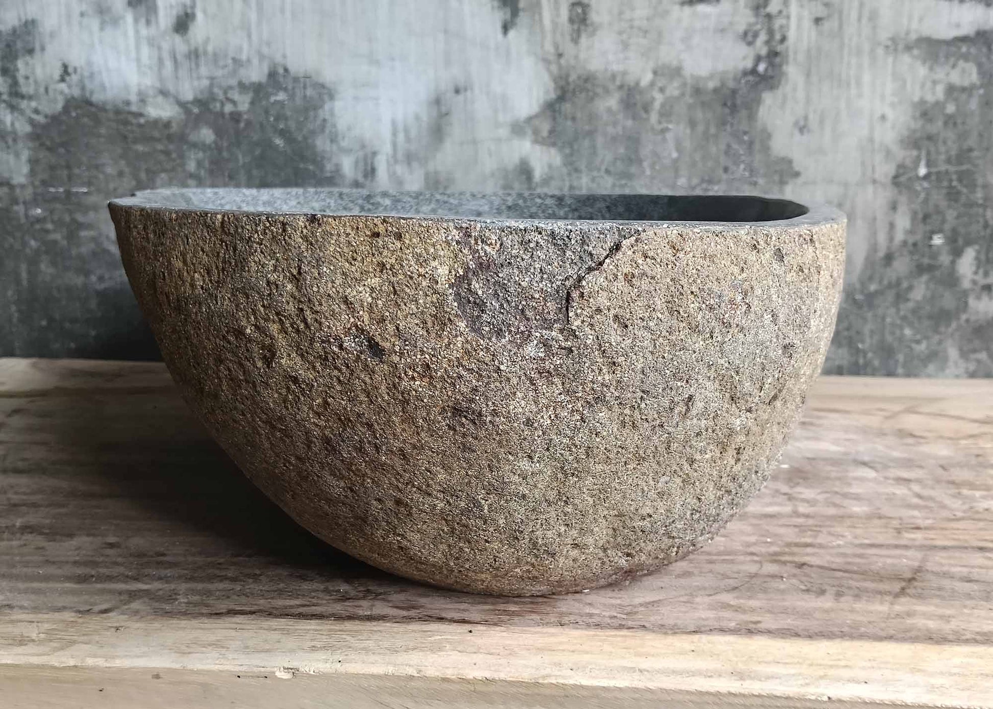 Left side of natural river stone basin 6099-4836 with raw stone finish
