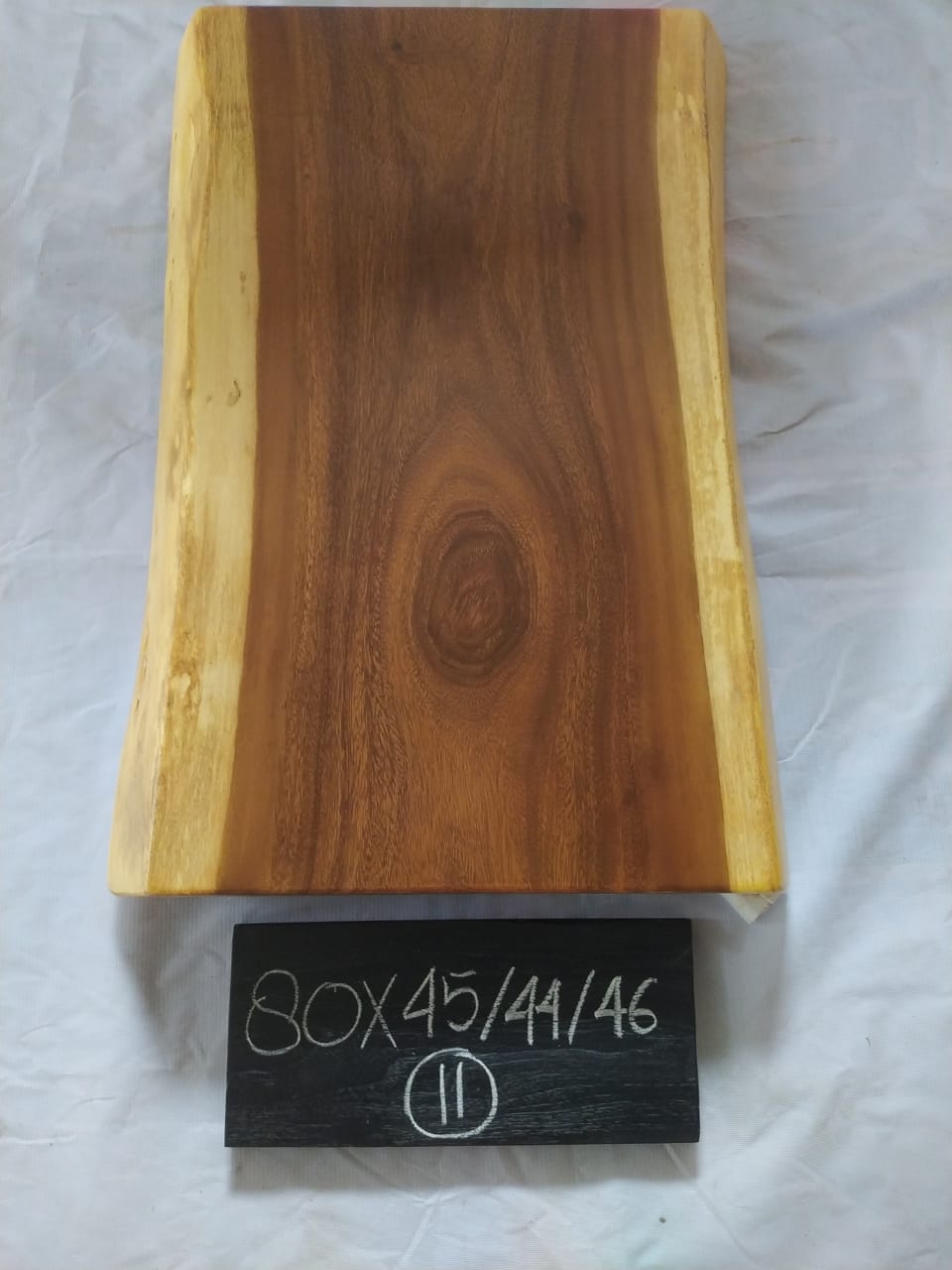 Top view of suar wood slab 0011-454446 with live edge shape and warm brown natural wood grain, solid single-piece countertop.
