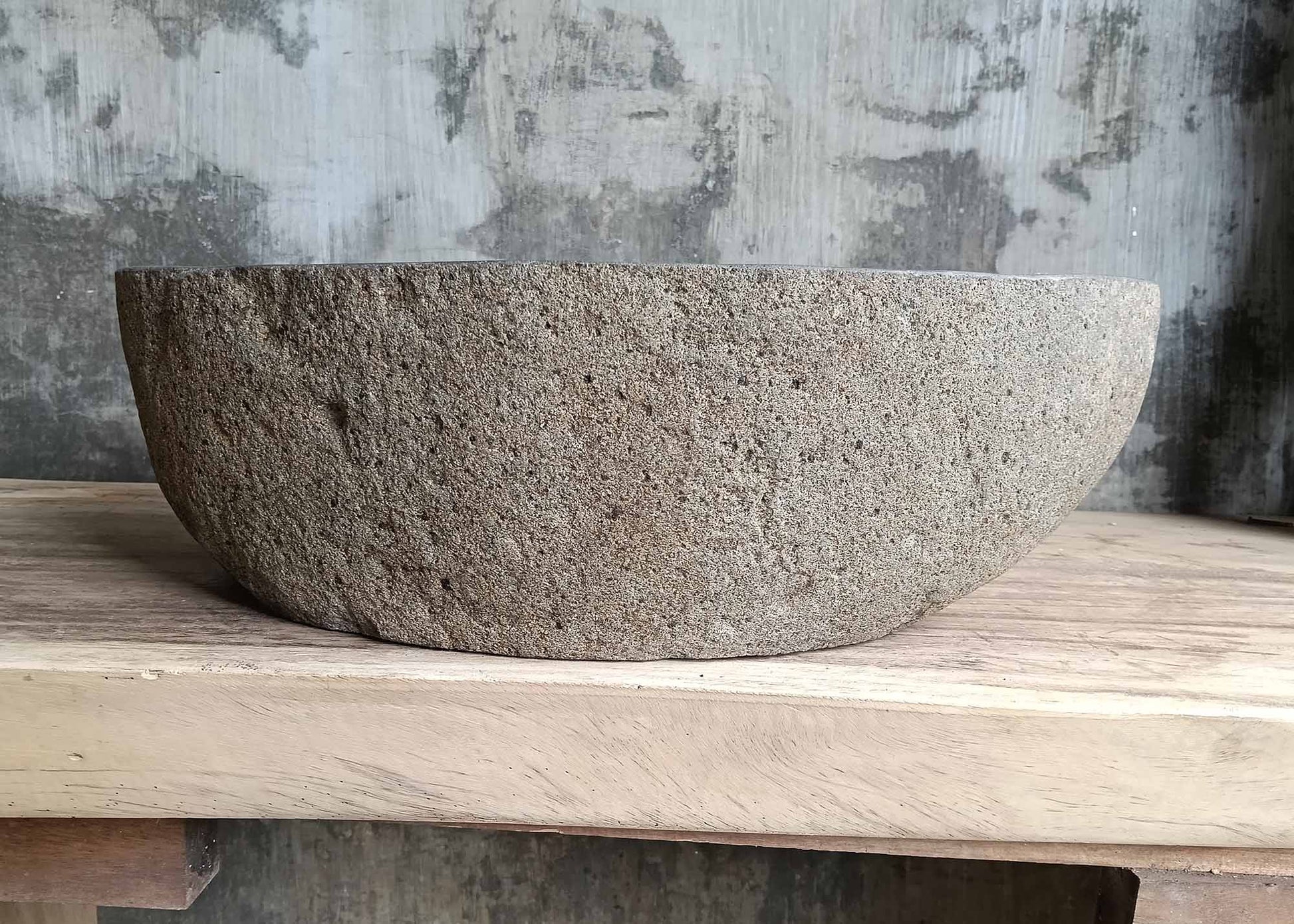 Rear view of oval river stone sink SKU 6116-5032 highlighting rough natural stone texture and smooth polished basin
