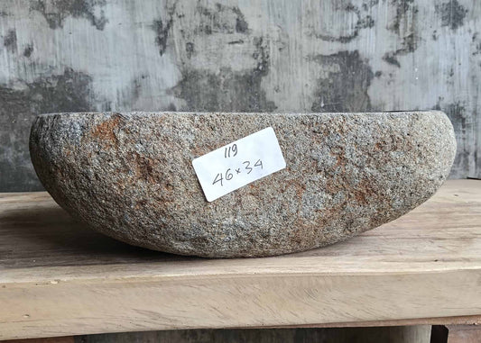 Front profile of handcrafted stone sink 6119-4634 showing raw edge texture
