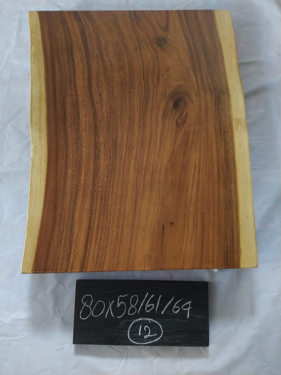 Top view of suar wood slab 0012-586169 with live edge shape and rich brown natural wood grain, solid single-piece countertop.
