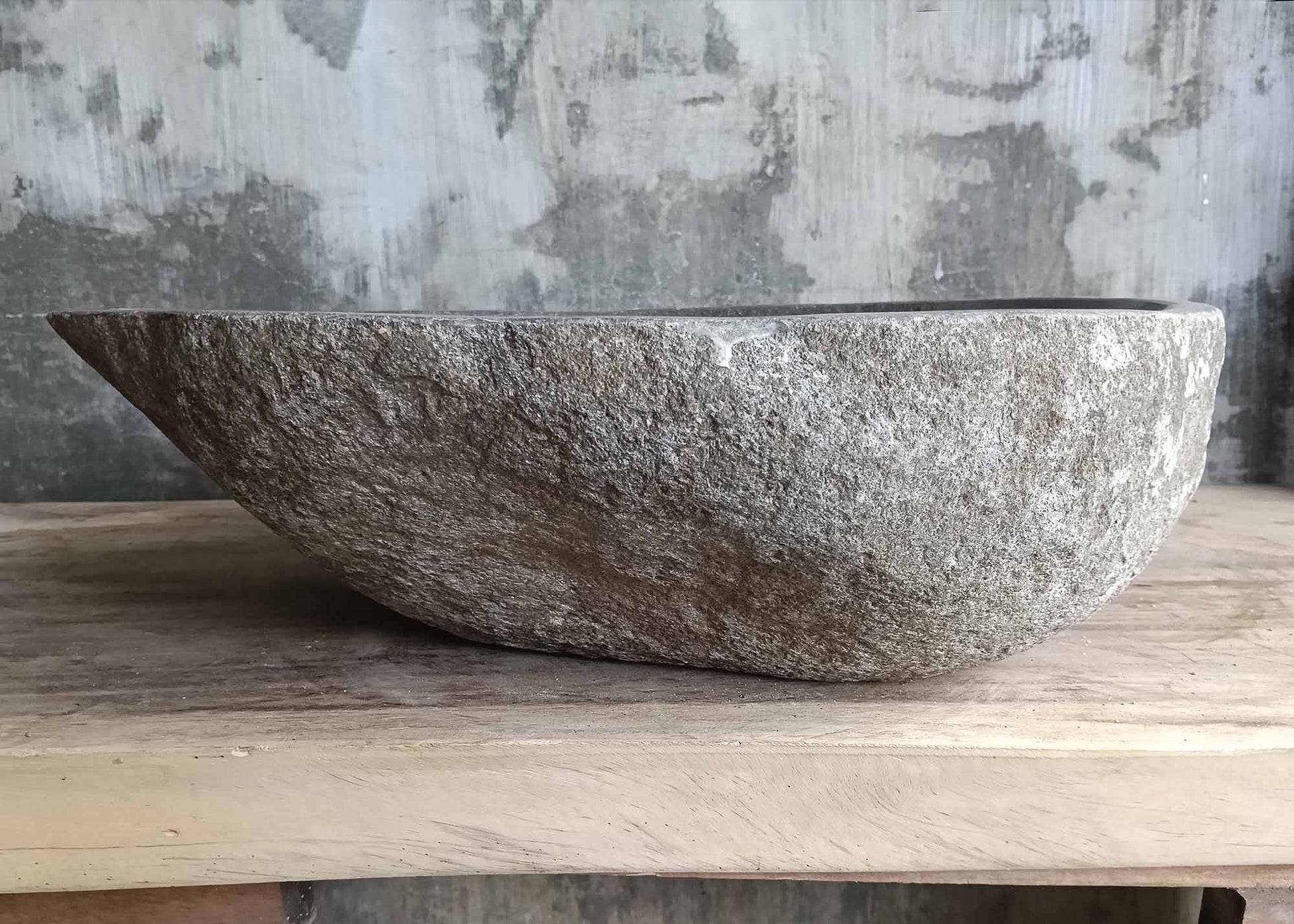 Right side view of river stone sink SKU 6148-5247 showing rugged granite surface and polished interior
