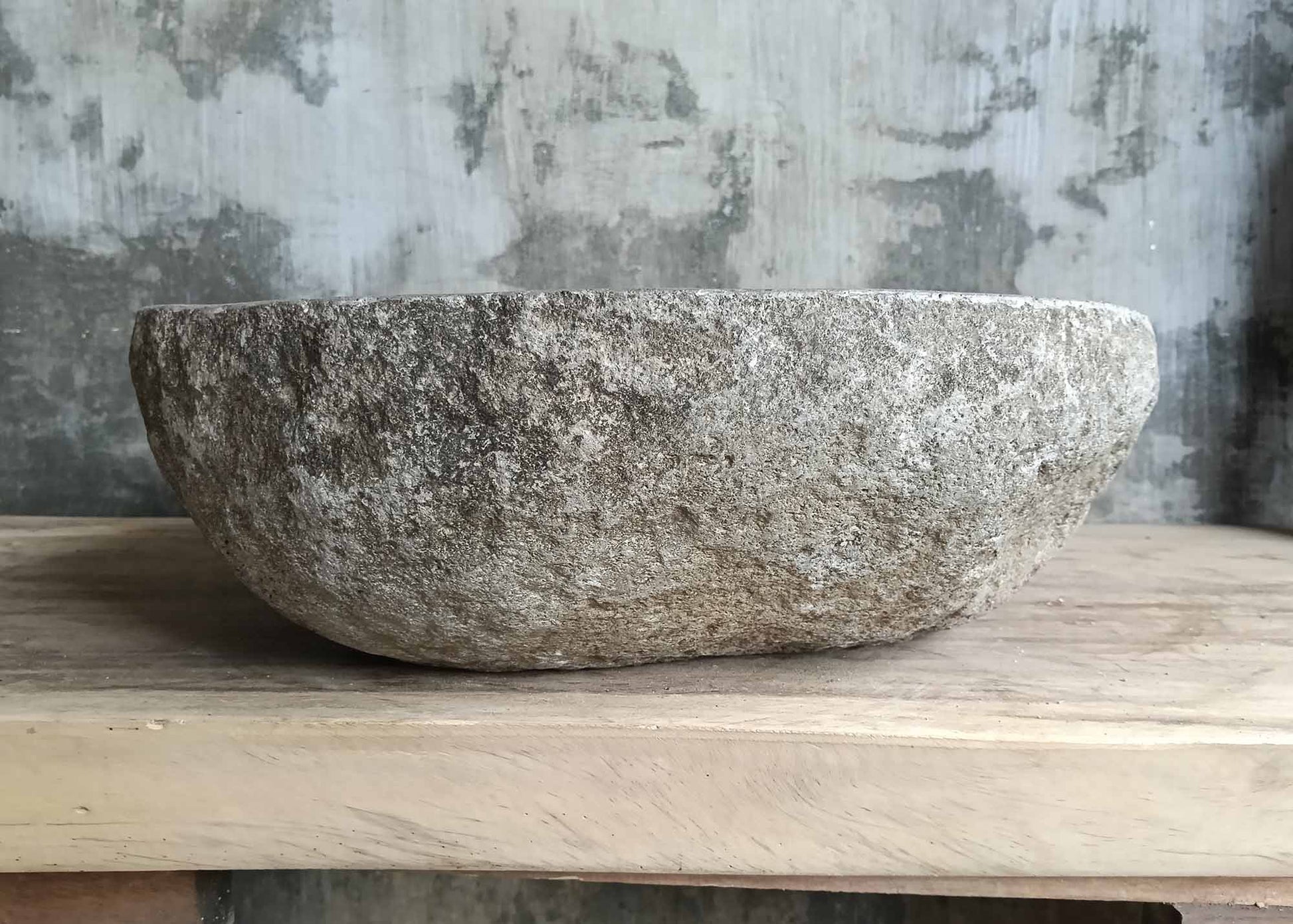 Rear view of river stone sink SKU 6148-5247 highlighting textured granite exterior and organic shape
