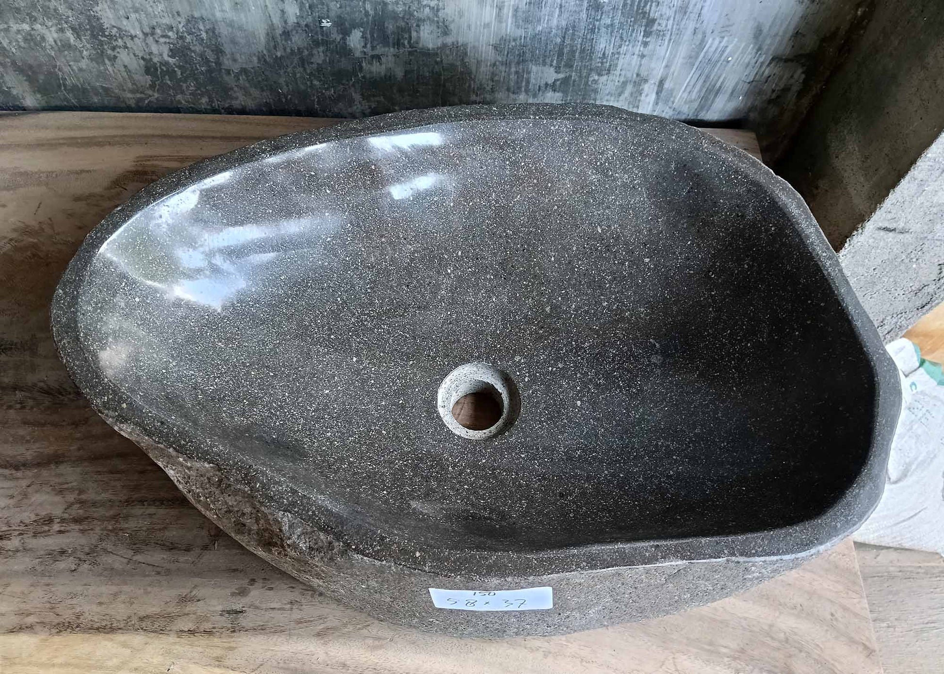 Top view of river stone sink SKU 6150-5837 with dark polished granite interior and curved organic shape
