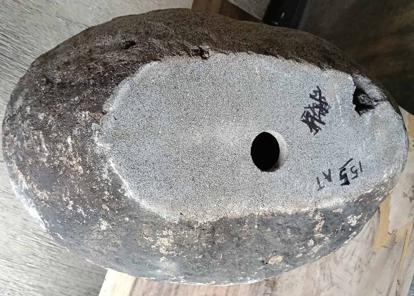 Bottom view of stone sink SKU 6155-5836 showing irregular granite base and size label visible
