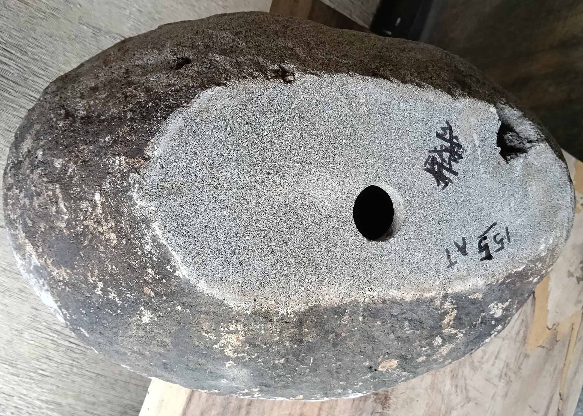 Bottom view of stone sink SKU 6155-5836 showing irregular granite base and size label visible
