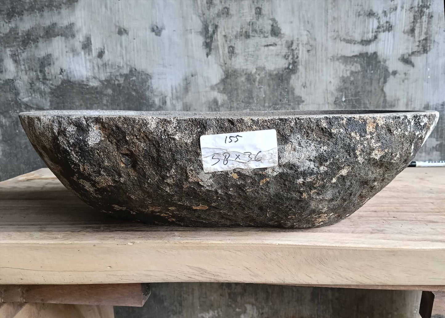 Front view of handcrafted river stone sink SKU 6155-5836 showing rough gray-black granite exterior
