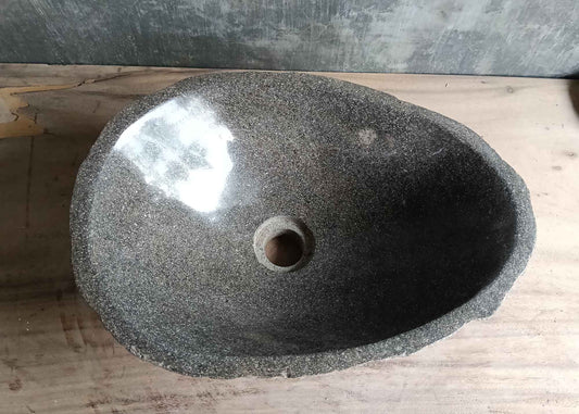 Top view of handcrafted 17×12 inch gray river stone sink with oval interior
