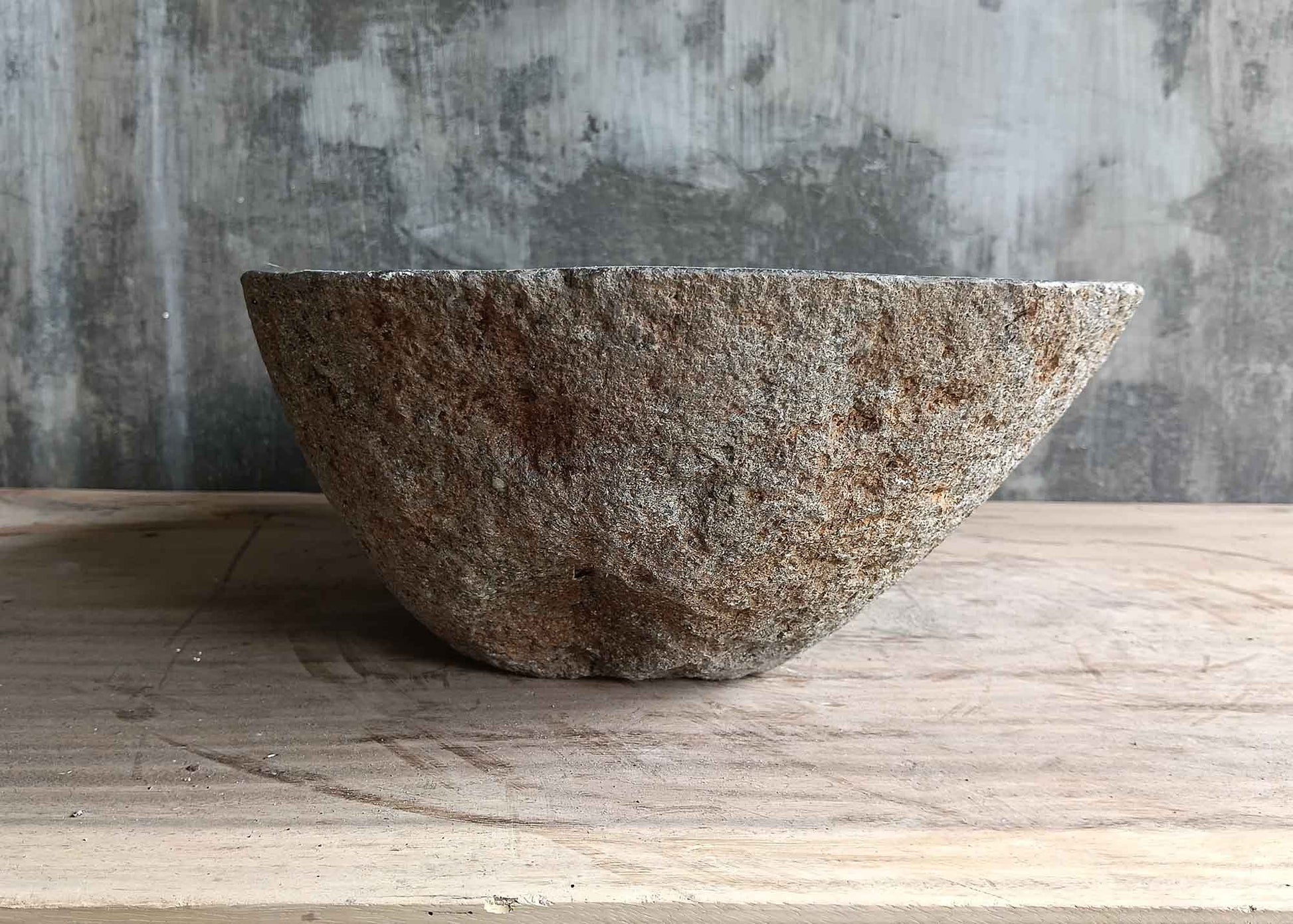 Left side view of handcrafted gray 17×12 inch river stone sink with oval shape

