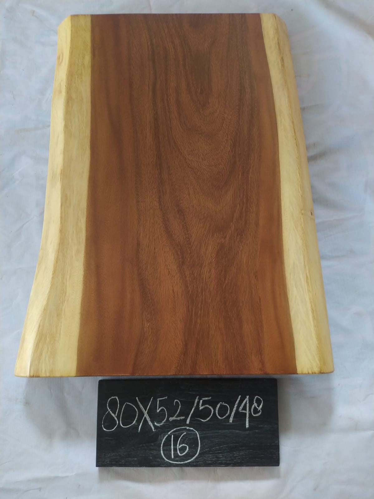 Top view of suar wood slab 0016-525048 with live edge shape and warm brown natural wood grain, solid single-piece countertop.
