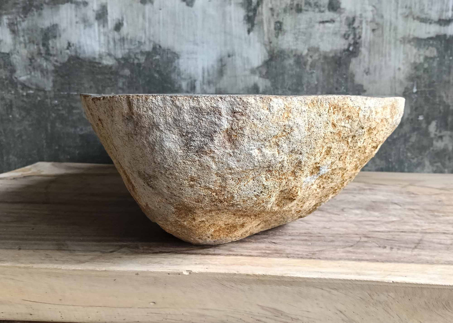 Left side of river stone sink SKU 6170-5437 showing raw golden exterior and deep interior curve
