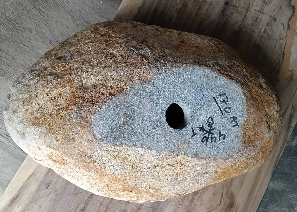 Bottom view of stone sink SKU 6170-5437 showing textured granite base and product label
