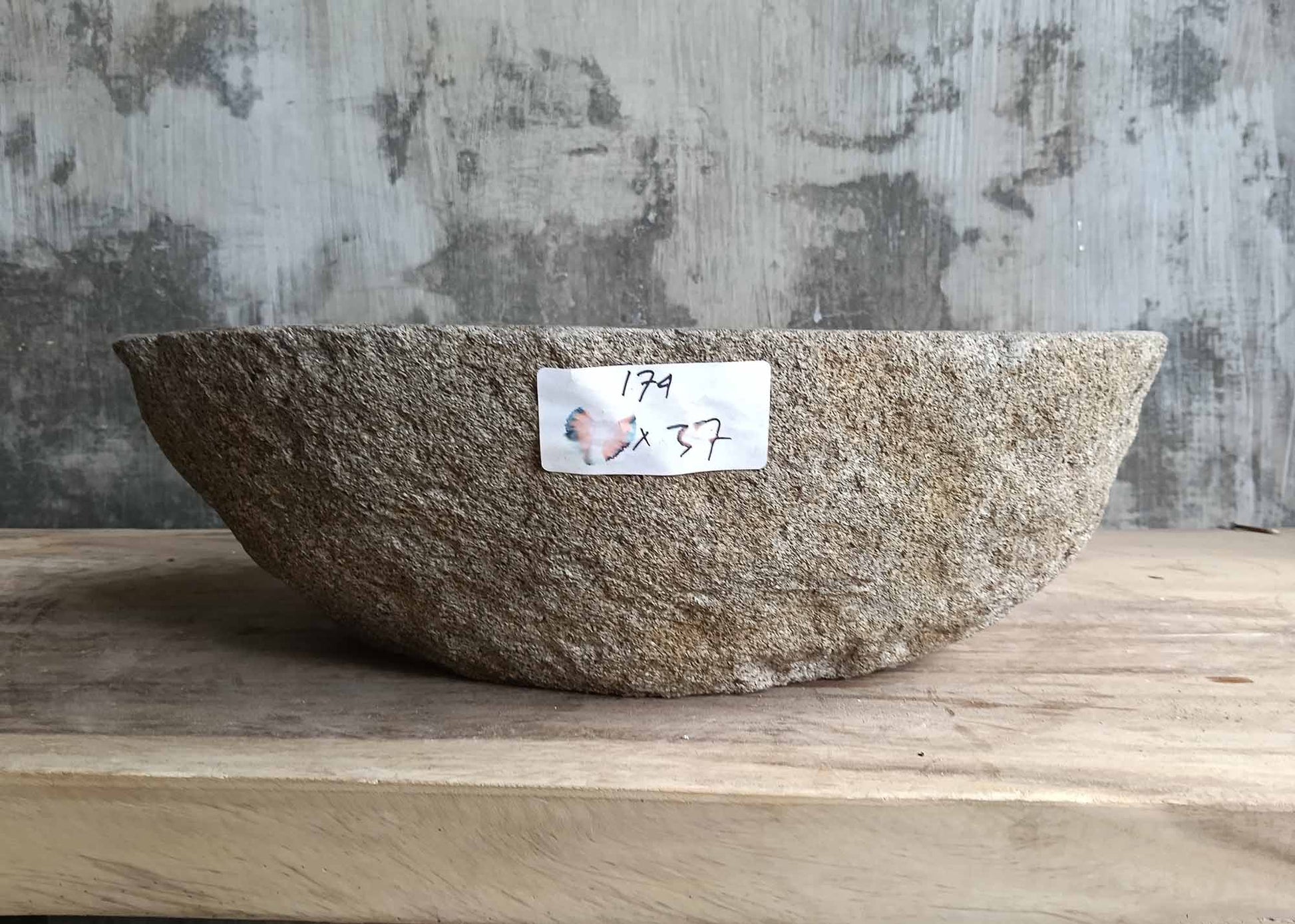 Front angle of handcrafted dark gray stone sink with rough outer surface – 6174-4637

