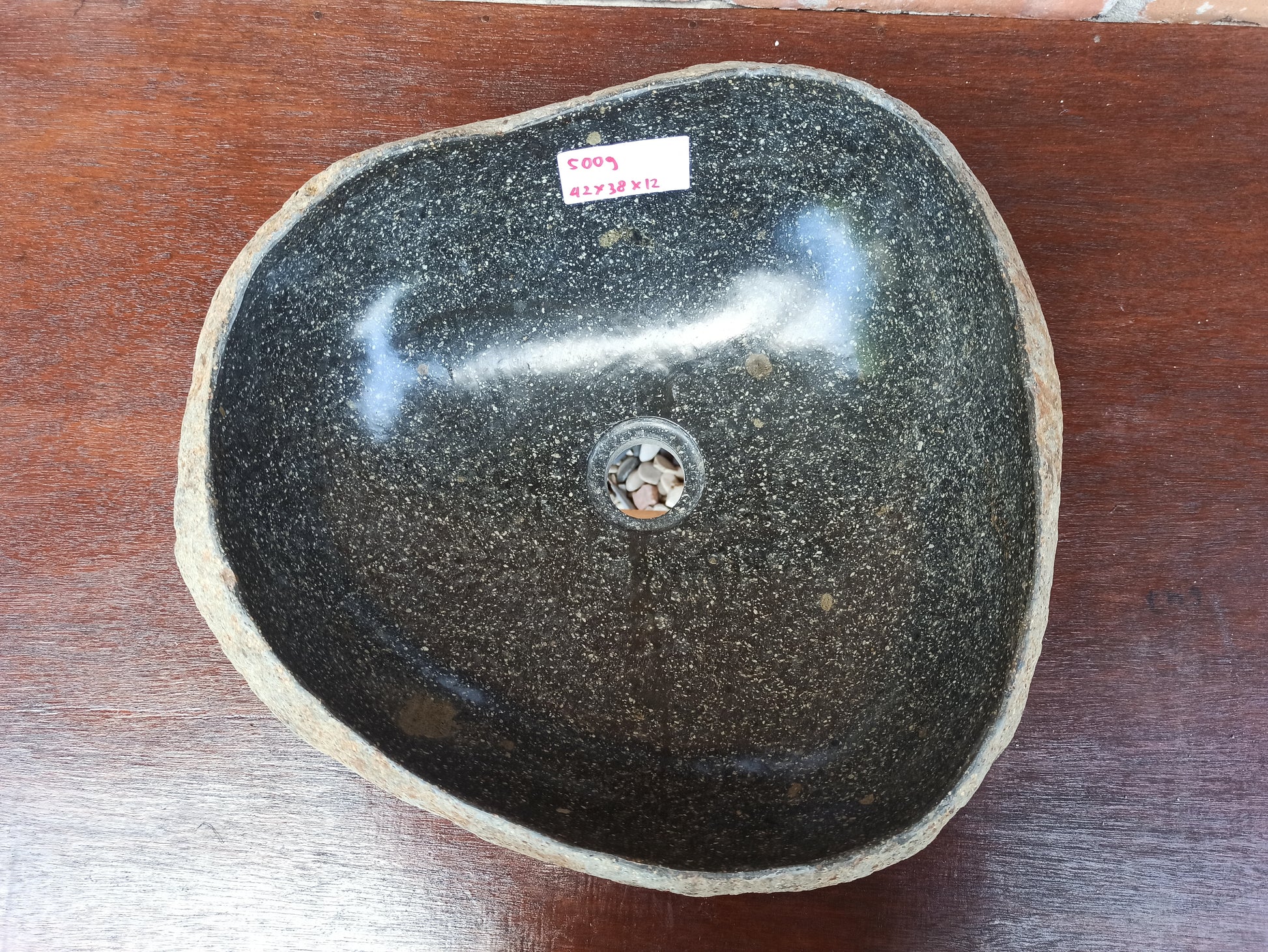Top view of 5009-423812 black river stone sink — polished interior, organic oval shape
