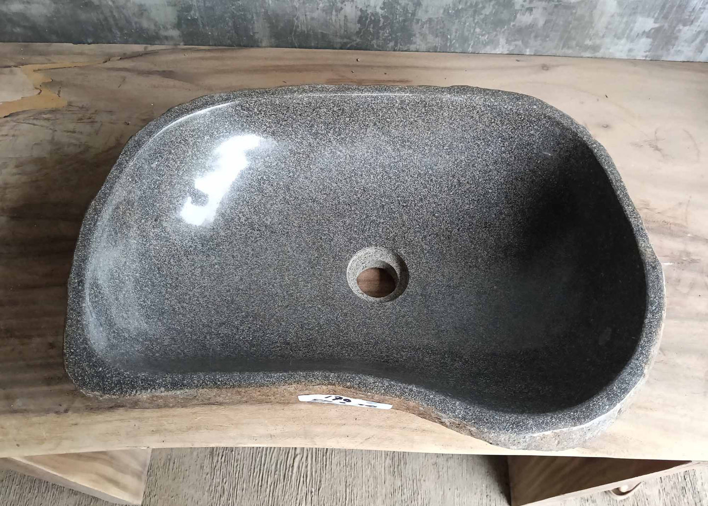 Top view of river stone sink SKU 6179-5034 with dark polished interior and gently curved rectangular shape
