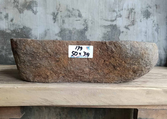 Front view of handcrafted sink SKU 6179-5034 showing rugged rust-colored stone exterior and deep basin
