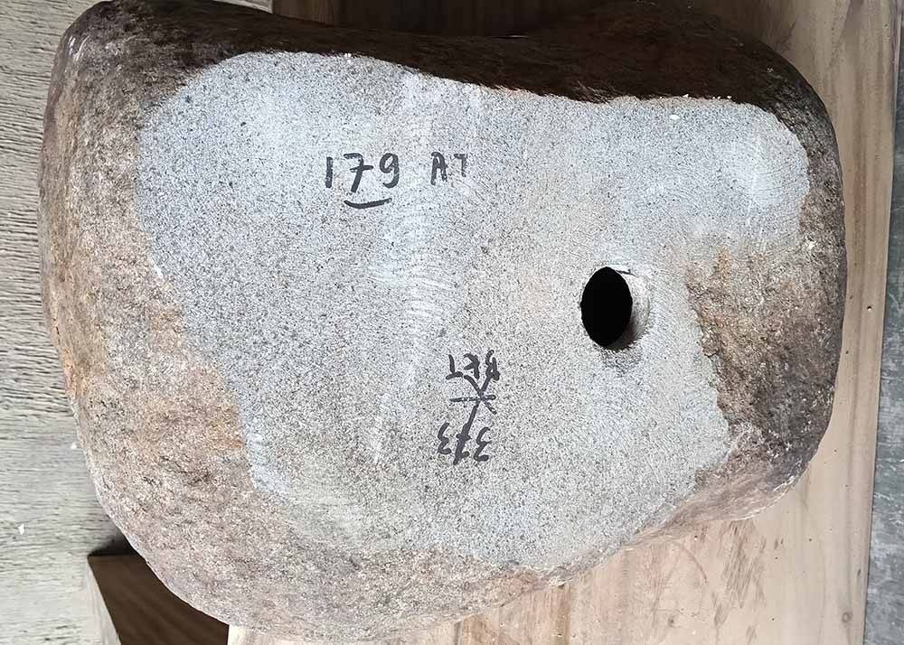 Bottom view of stone sink SKU 6179-5034 showing raw granite base and size label
