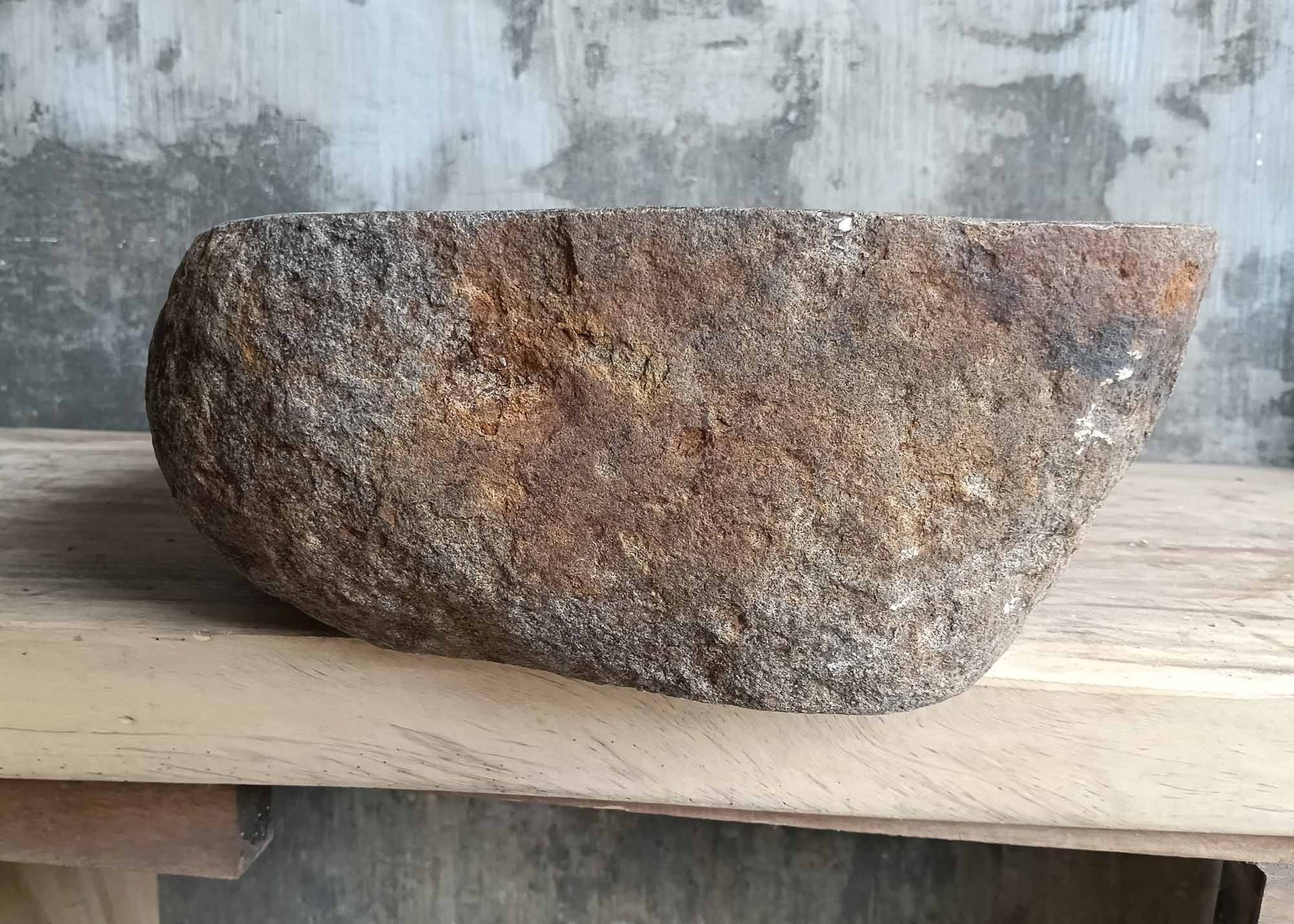Left side of river stone sink SKU 6179-5034 with natural stone patina and carved smooth edge
